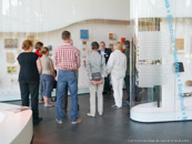 Group of guests in front of cabinets at the ‘Signs – Books – Networks’ exhibition organised by the German Museum of Books and Writing in Leipzig