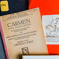 Bookplate belonging to Gottfried Bermann, in the foreground an older edition of the publication "Carmen. An Opera in Four Acts" Bookplate belonging to Gottfried Bermann, in the foreground an older edition of the publication "Carmen. An Opera in Four Acts"